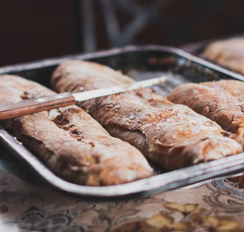 A freshly baked sourdough loaf, its golden crust sliced open to reveal a soft, airy interior